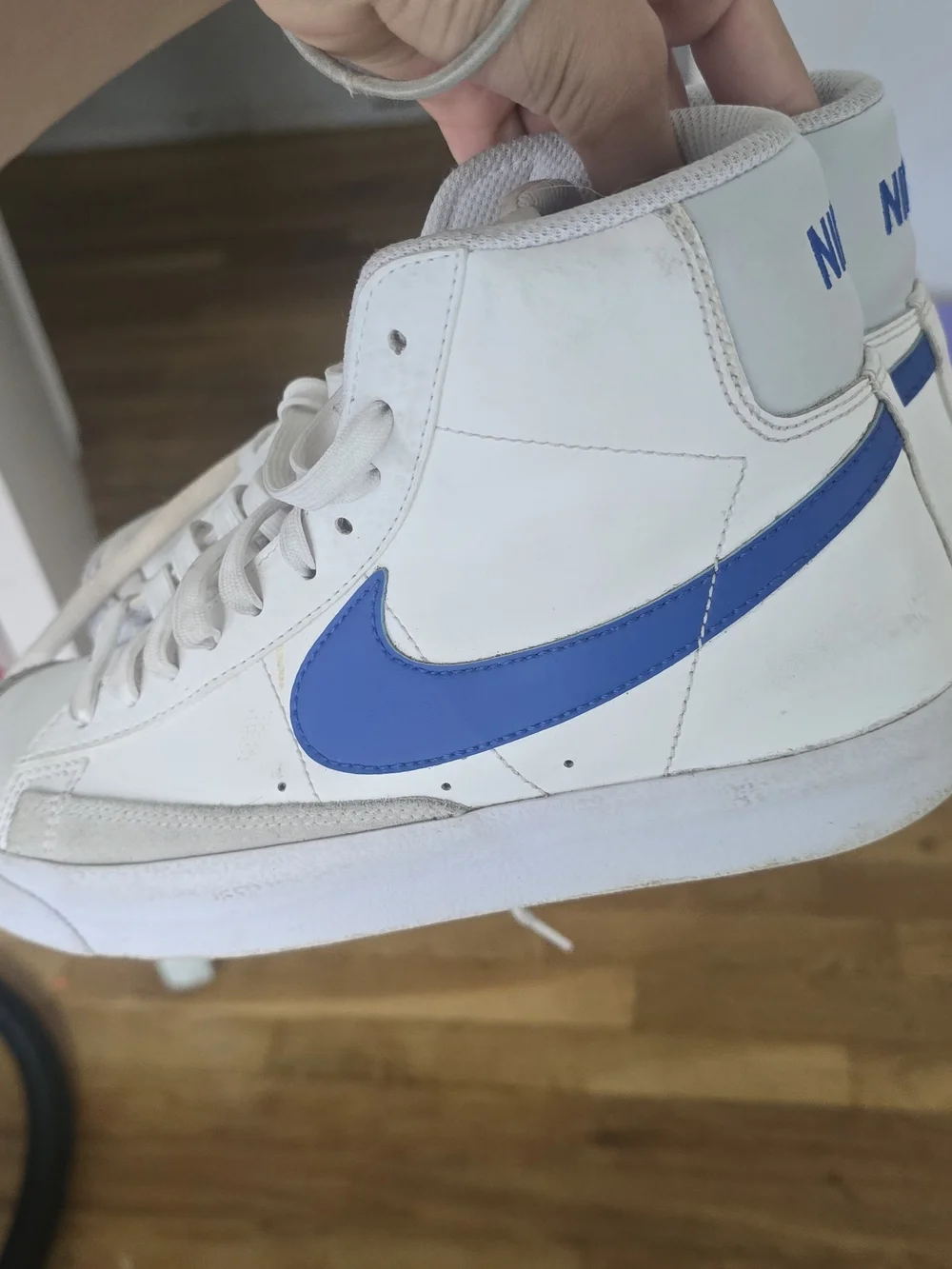 Nike White High-Top Sneakers with Blue Swoosh
